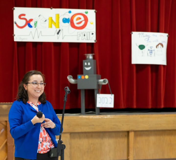 Our beloved 3rd Grade Teacher, Ms. Andra Urra (coordinator of the event) welcomes visitors and congratulates students on their accomplishments.