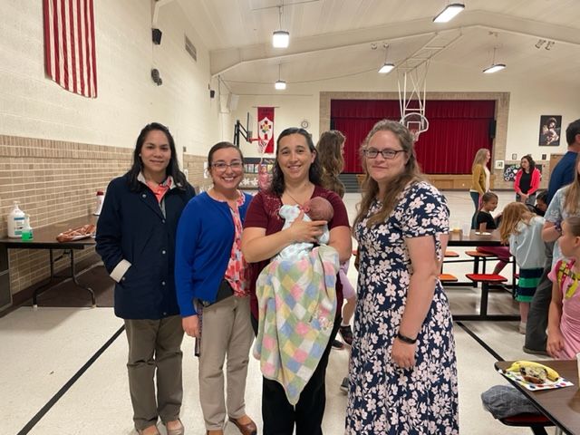 Miss Navarro, Ms. Andrea and Mrs. Hruby pose with Mrs. Krejchik and baby Isabella Mae.