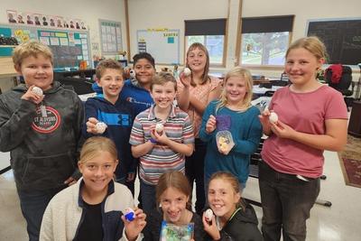 Mrs. Hruby's 5th grade class poses with their eggs (aka their "souls"): Front L to R: Cloudia Haselwander, Lucy Sauter, Brynn Dischler. Middle L to R: Matthew Heiney, Sam Ederer, Evan Cunningham, Rhylan Muller, Meg Brickl. Back L to R: Emmanuel Alvarado and Savannah Ziegler.