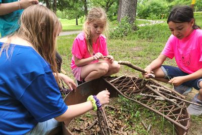 5th graders Laura Kruchten, Kayla Ederer and Fatima Gonzales put their fire-building skills to the test.