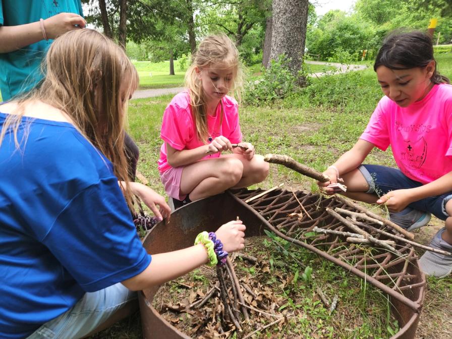 5th graders Laura Kruchten, Kayla Ederer and Fatima Gonzales put their fire-building skills to the test.
