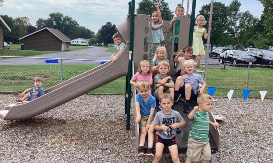 Students gathered on the playground climbing structure during the first days of school.