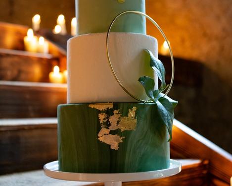 three-tier wedding cake wedding cake in green and white with gold decoration