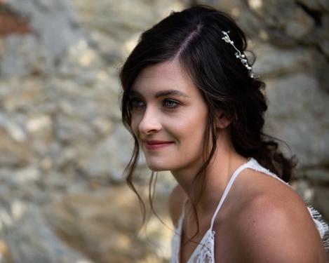 Portrait of the bride in front of a rustic stone wall