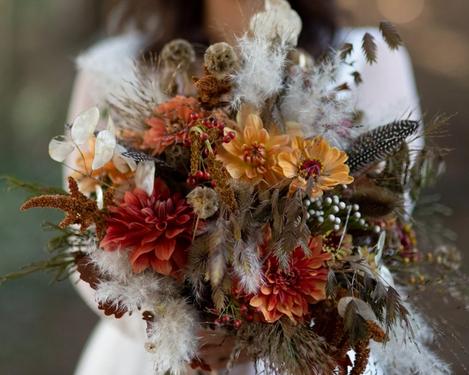 Close up of autumn bridal bouquet held by bride