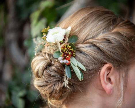 Brautfrisur mit eingearbeiteten Blumen