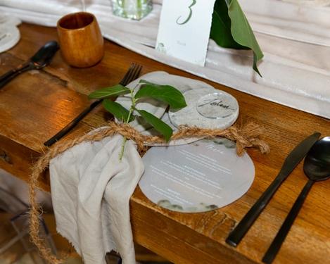Place setting with menu card and name card on a rustic table 