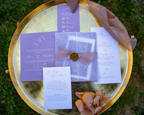Wedding stationery on gold coloured tray in the meadow