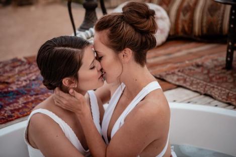 A same-sex female couple kissing.