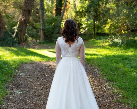 Rückenansicht einer Braut in weißem Kleid im Freien