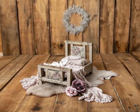 Antique style newborn wooden cot in grey with pink flowers on it