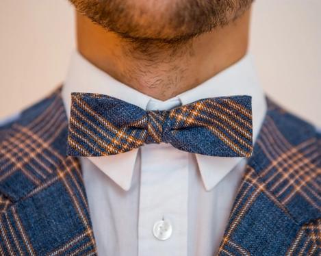 Detailed view of Groom's bow tie hat with jacket, in blue orange check pattern