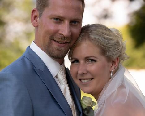 Portrait of the bridal couple, both smiling into the camera