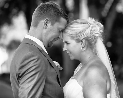 Bride and groom standing forehead to forehead, b/w picture