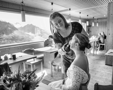 Getting ready the bride in a hut with a view of the mountains