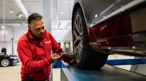 Man utför kontroll på bil.