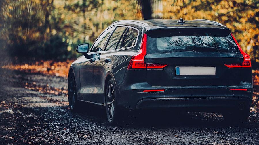 Bilen er parkeret langs en landevej.