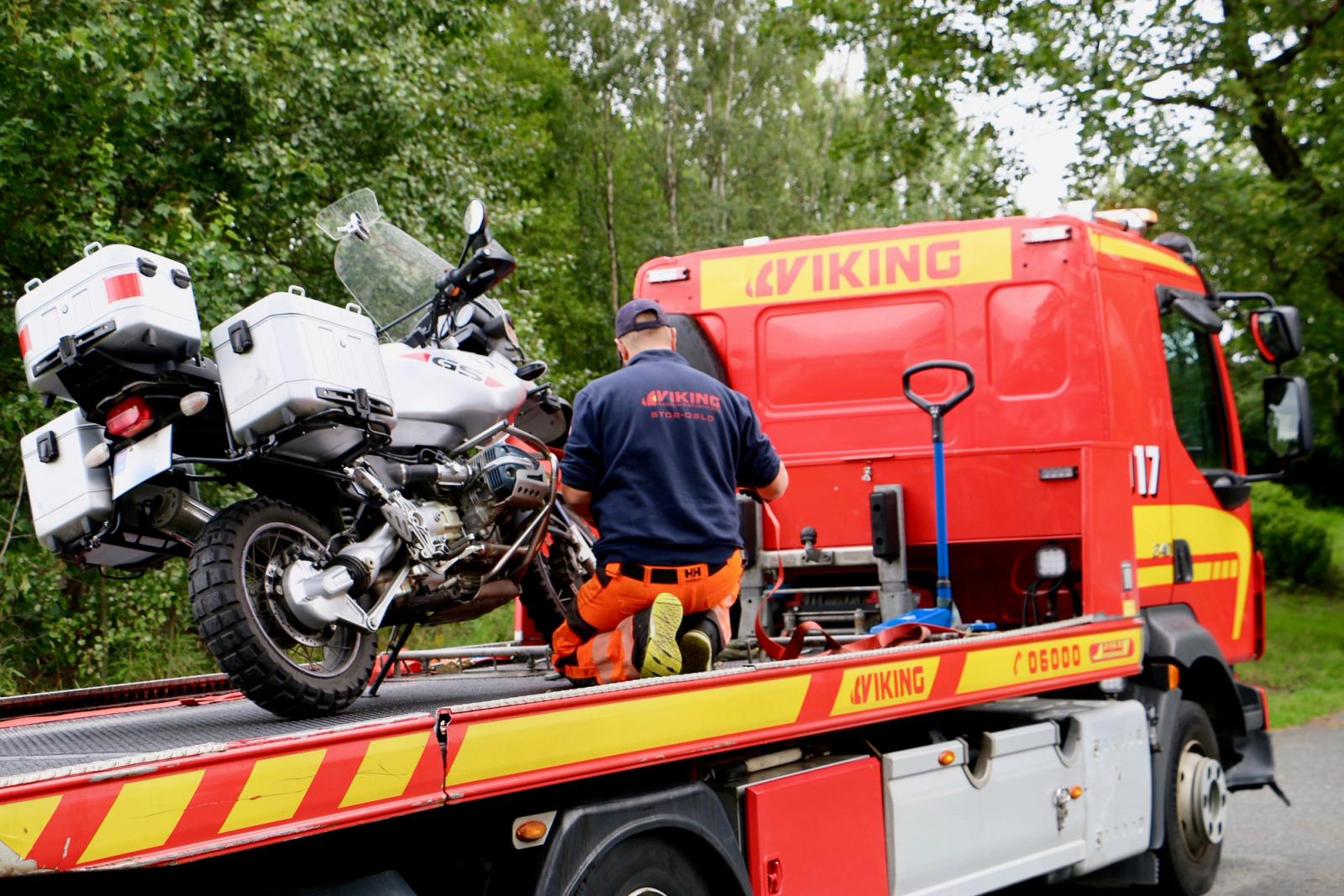 Viking hinausauton lavalla on moottoripyörä, jota "Viking"-univormuun pukeutunut henkilö kiinnittää.