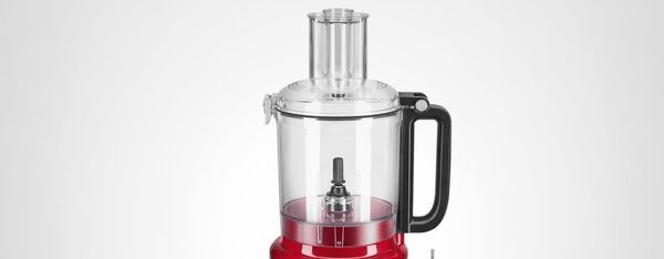 KitchenAid 9-Cup Food Processor in Empire Red with attachments, work bowl, and accessories displayed on a white surface.