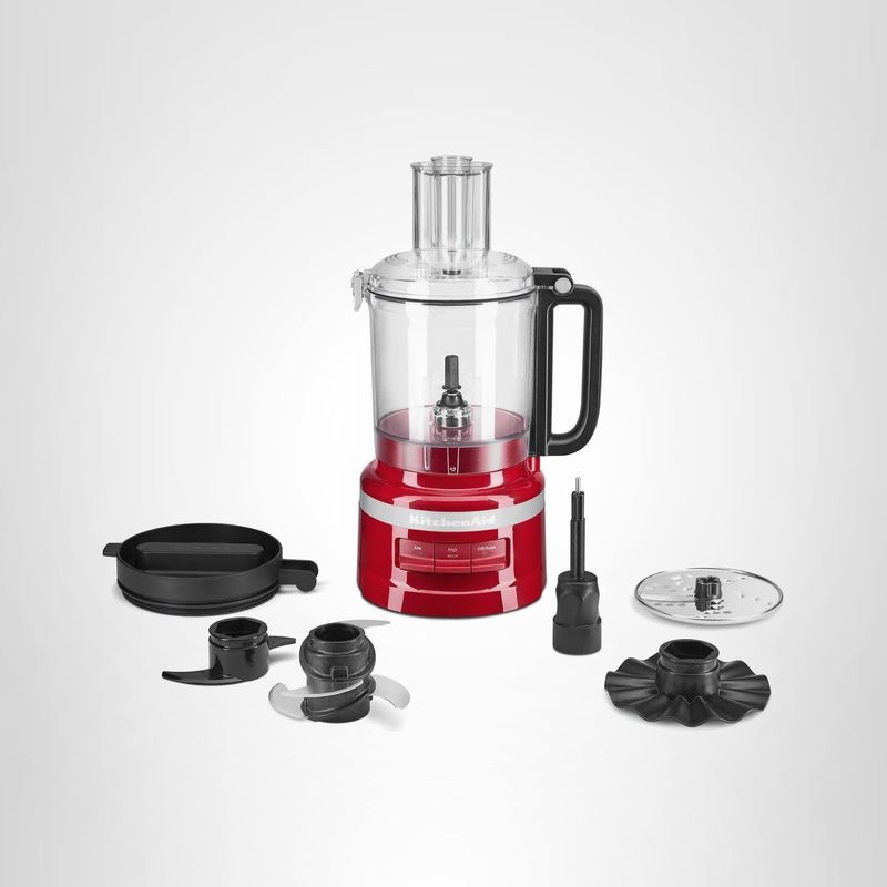 KitchenAid 9-Cup Food Processor in Empire Red with attachments, work bowl, and accessories displayed on a white surface.