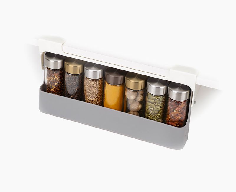 Joseph Joseph gray CupboardStore spice rack lowered beneath a shelf with spice jars inside