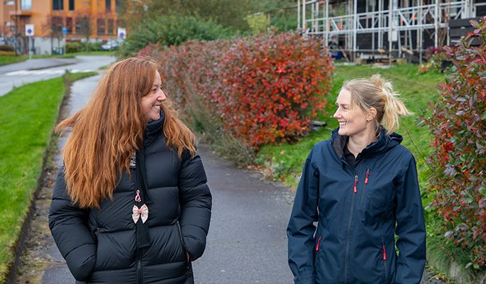 To damer går på fortauet.