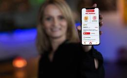 Dame holder mobil med Bate-appen på