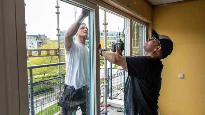 Thomas Søyland og John Sandanger fra Byggmester Sagen setter inn nye vinduer. 