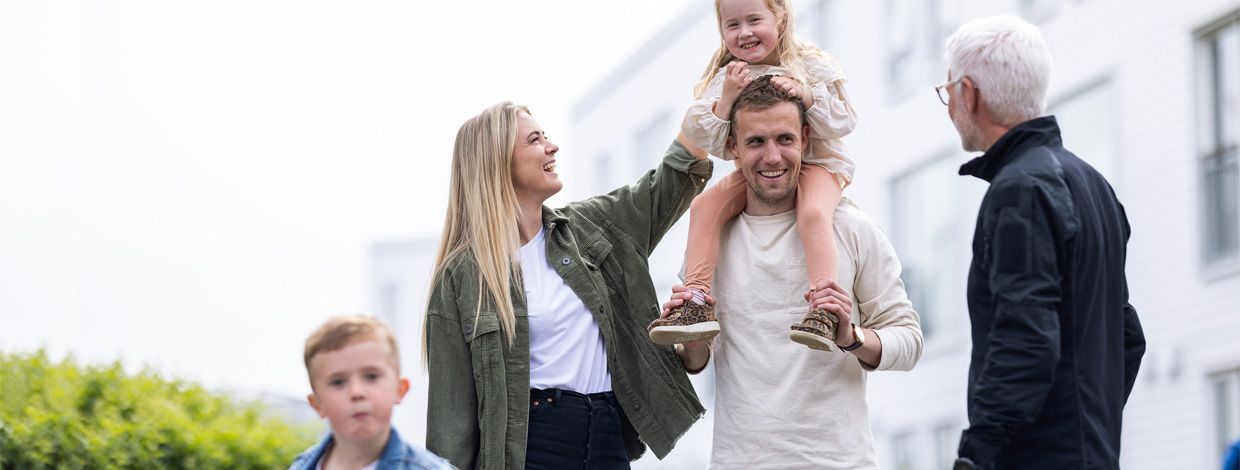 voksne og barn som prater og leker ute