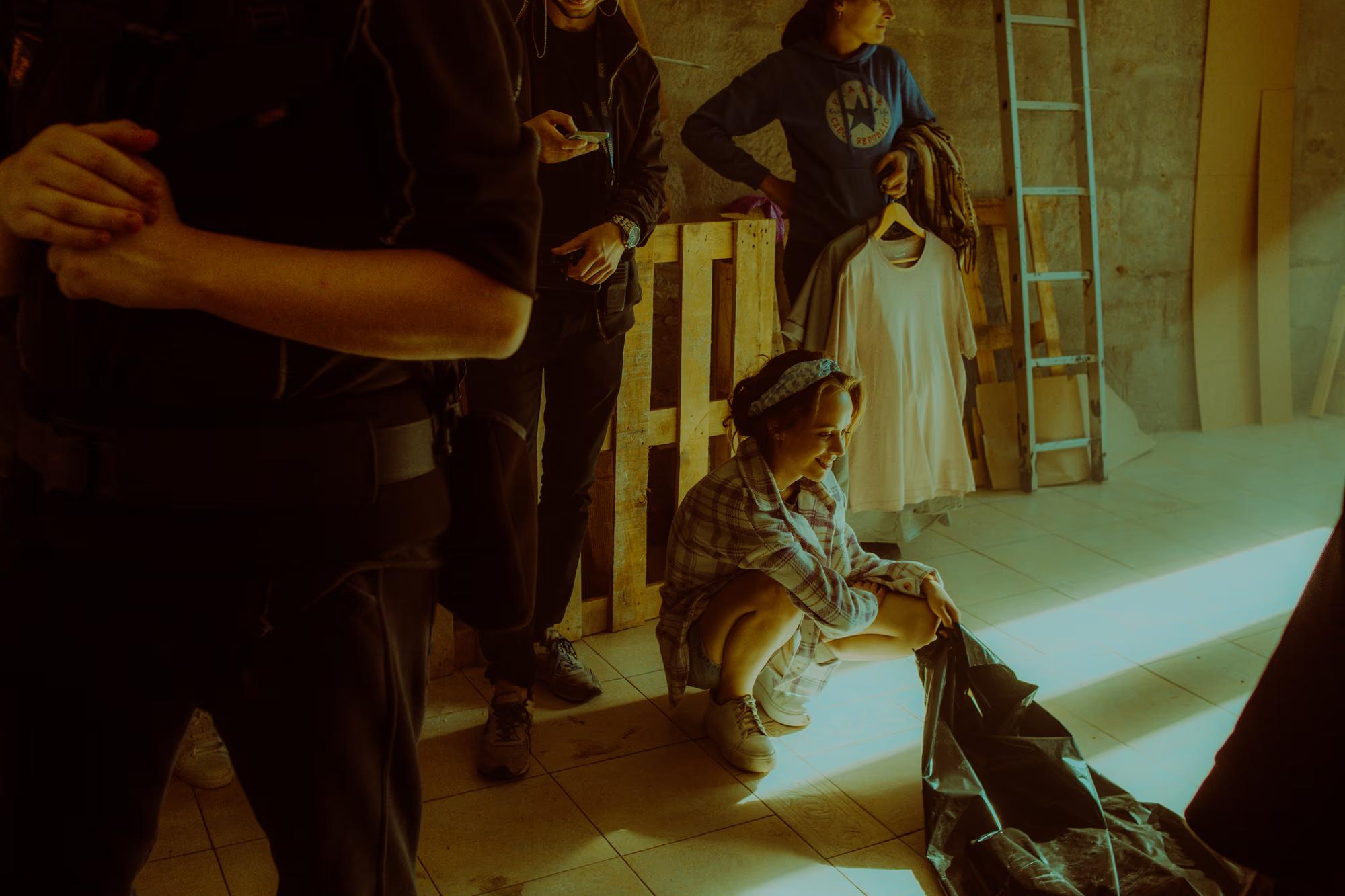 Behind-the-scenes shot of a dolly track setup and camera movement during a professional video production.