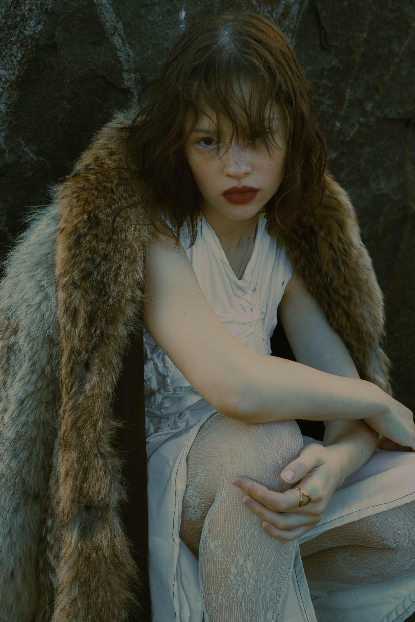 Full body fashion art shot of woman in white flowing dress with wild dark hair in forest, ethereal dark fantasy editorial