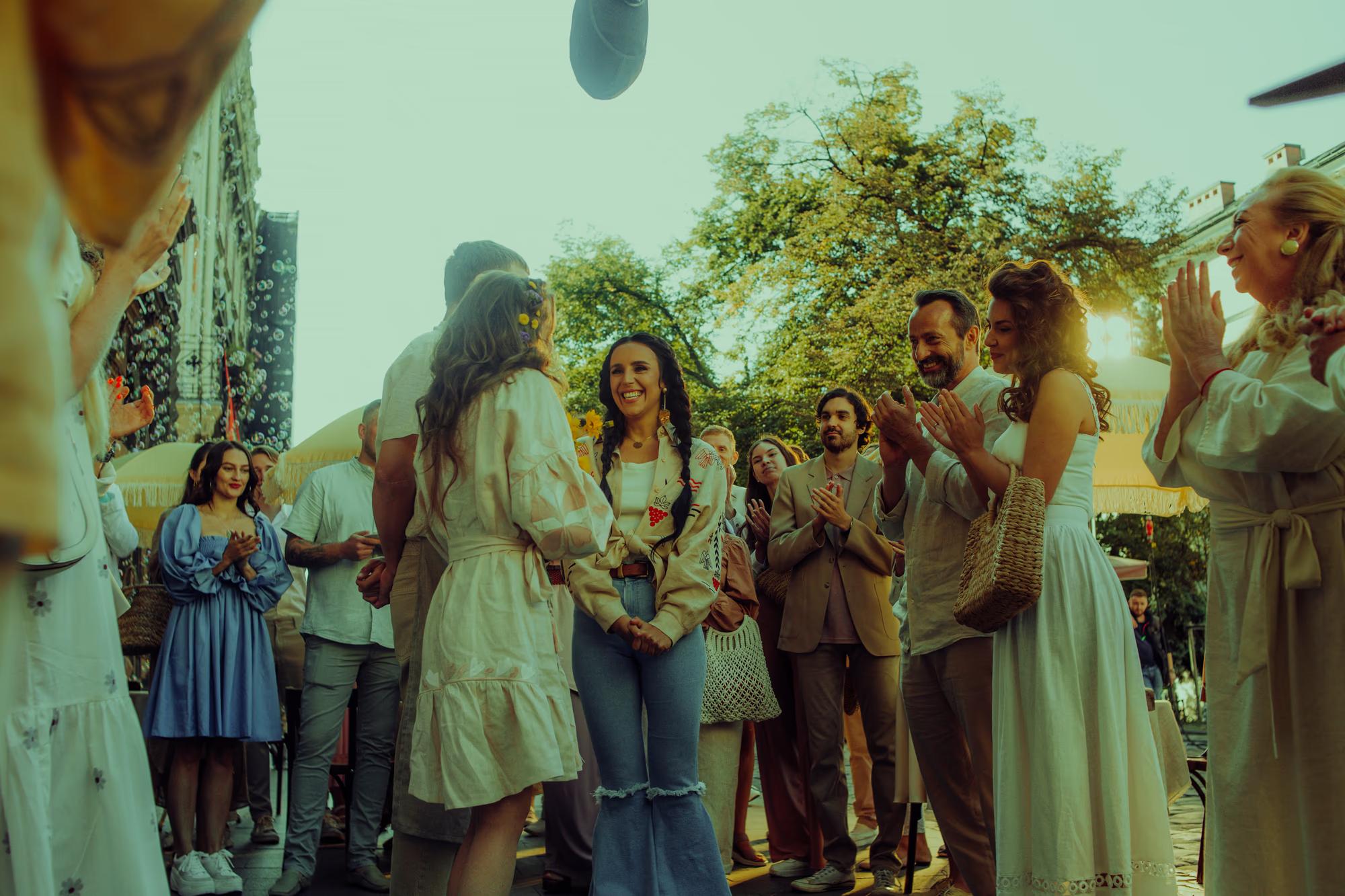 Group of actors and crew gathered on an old European-style street during a movie shoot in Lviv city center.