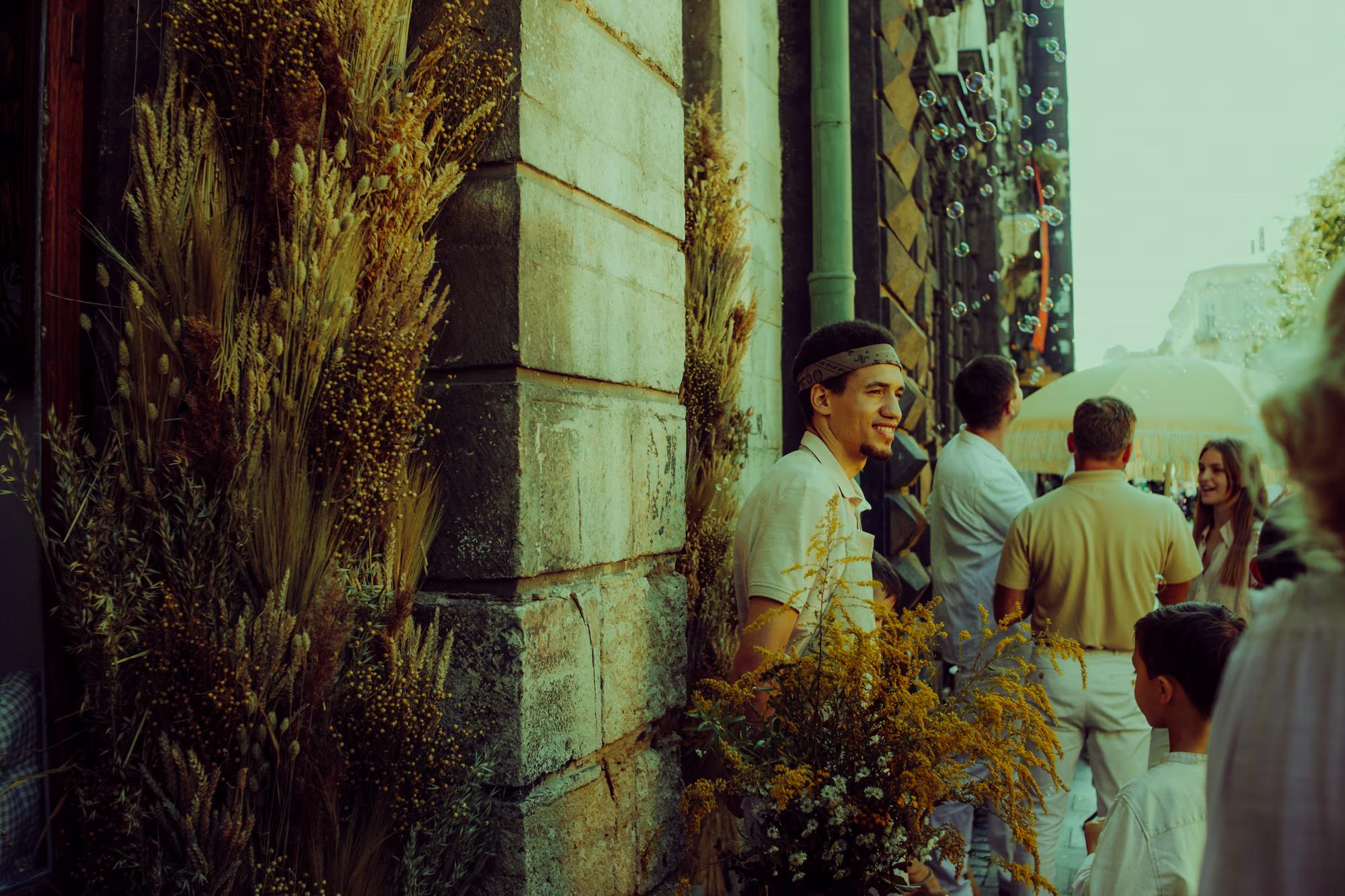 Cinematic light hitting an old stone wall as the film crew prepares for an evening scene.