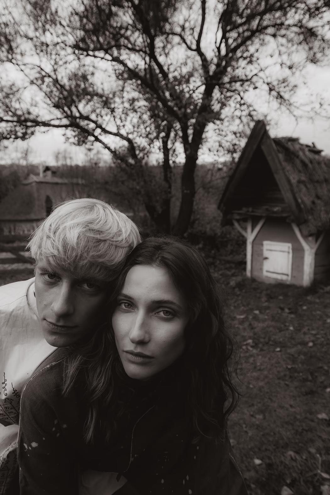 Artistic portrait of a model in a textured hood, capturing a soulful "Northern-folk" vibe within the Kyiv ethno-landscape.