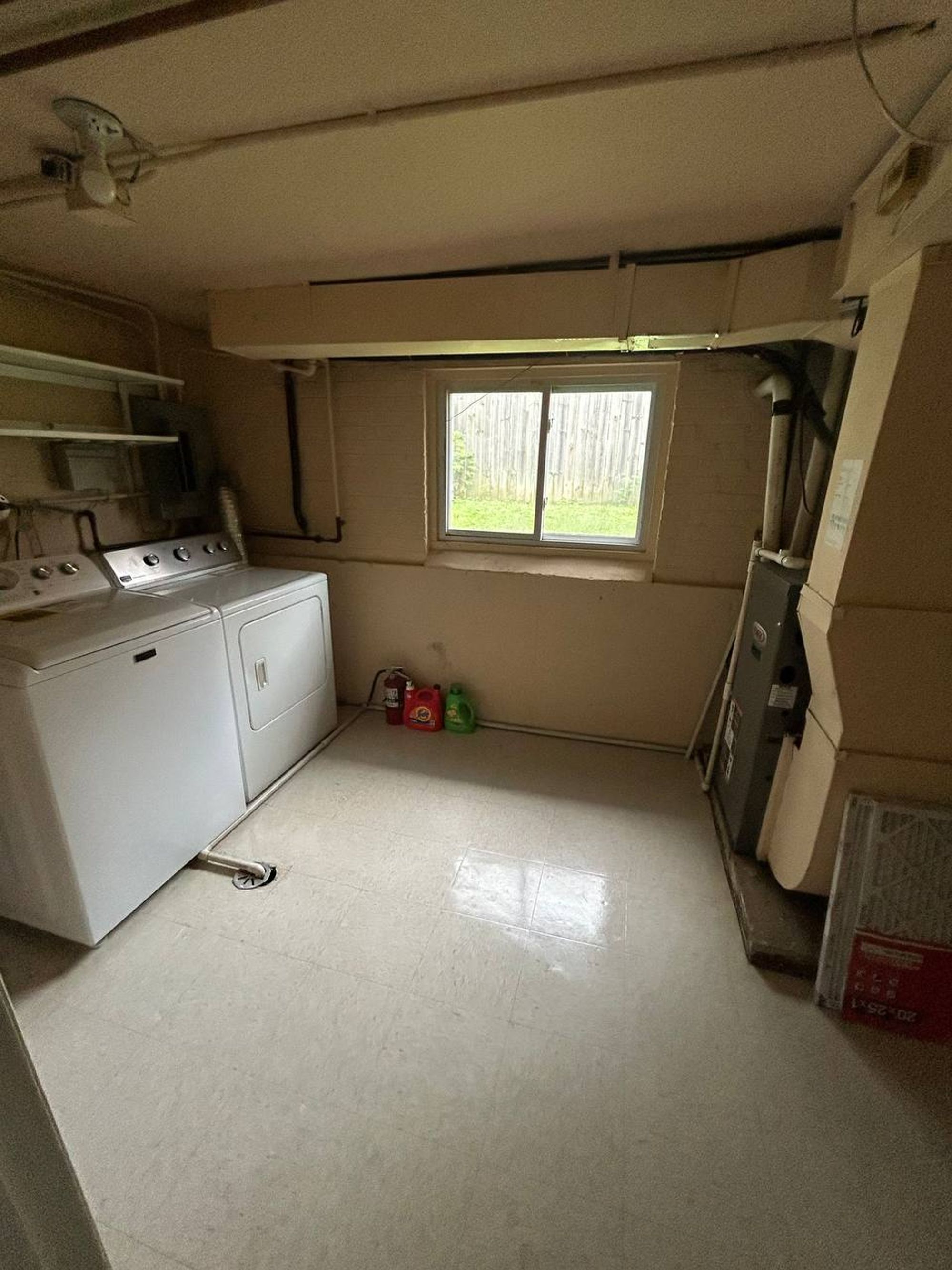 Basement laundry room with washer, dryer and mopped tile floor