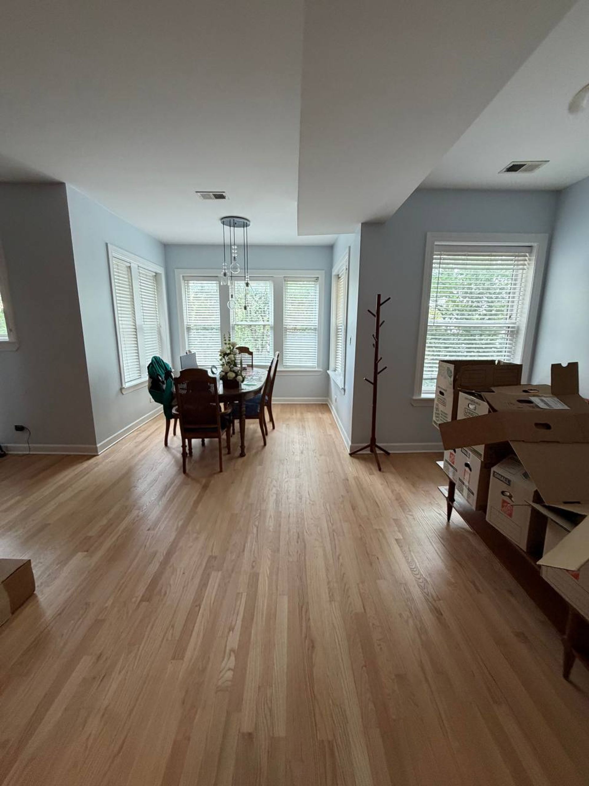 Open dining area with oak floors and bright windows