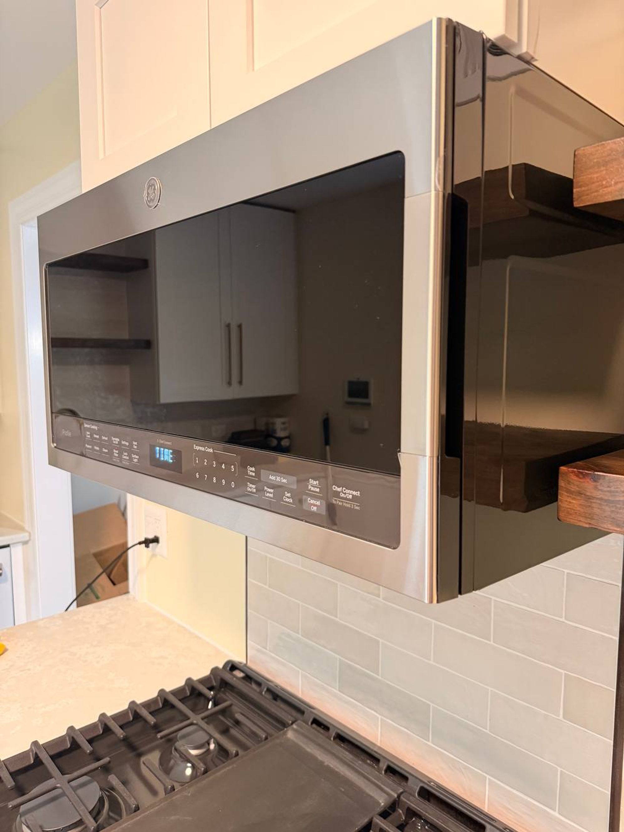 Stainless microwave above the range with glass door wiped clear