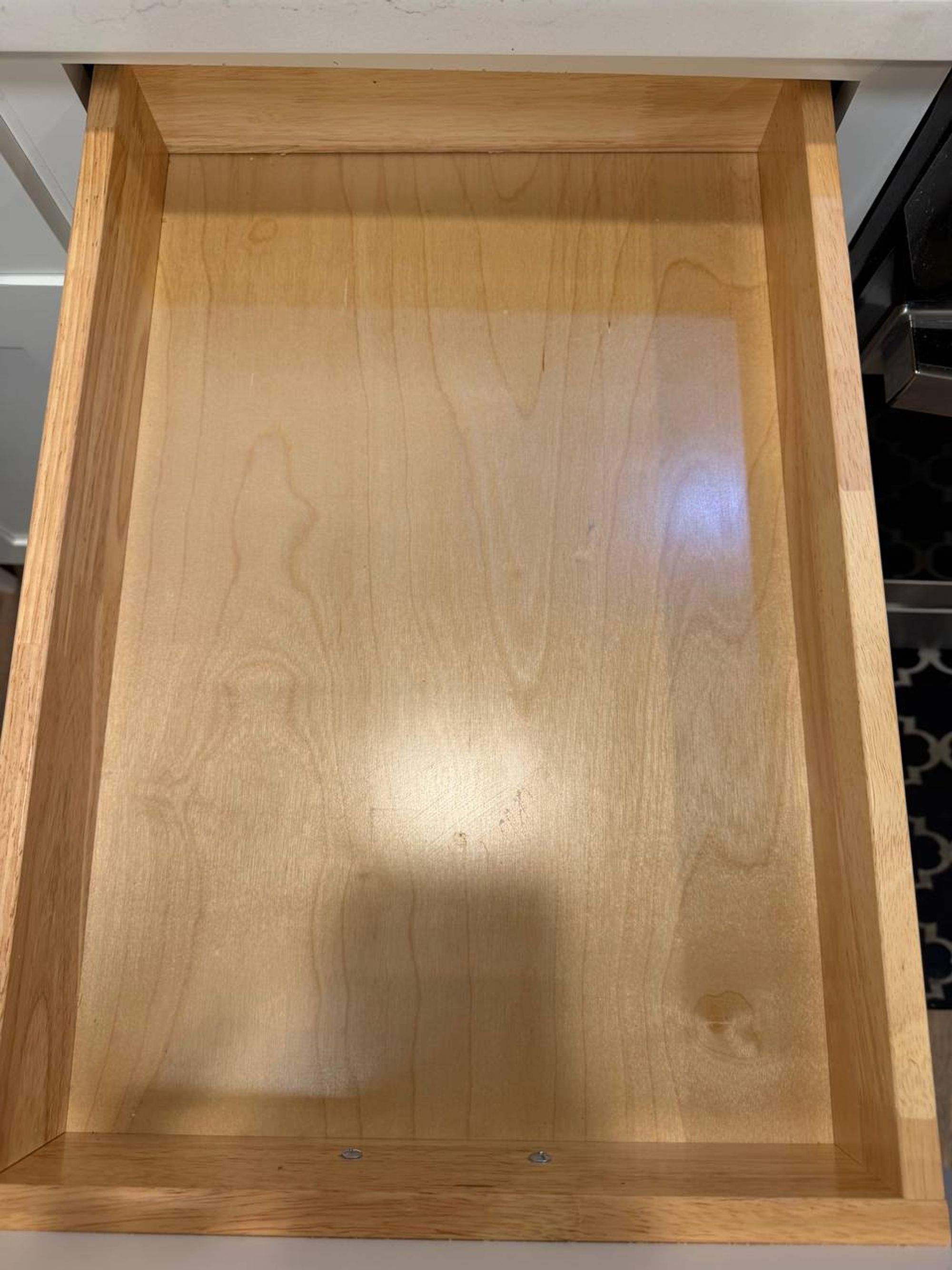 Empty kitchen drawer wiped clean down to bare wood