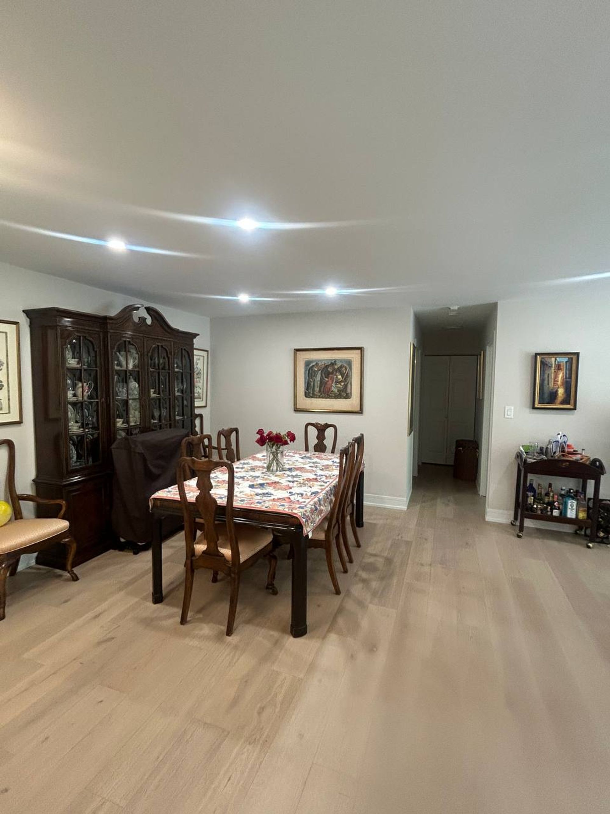 Dining room with wood table, china cabinet and light oak floors