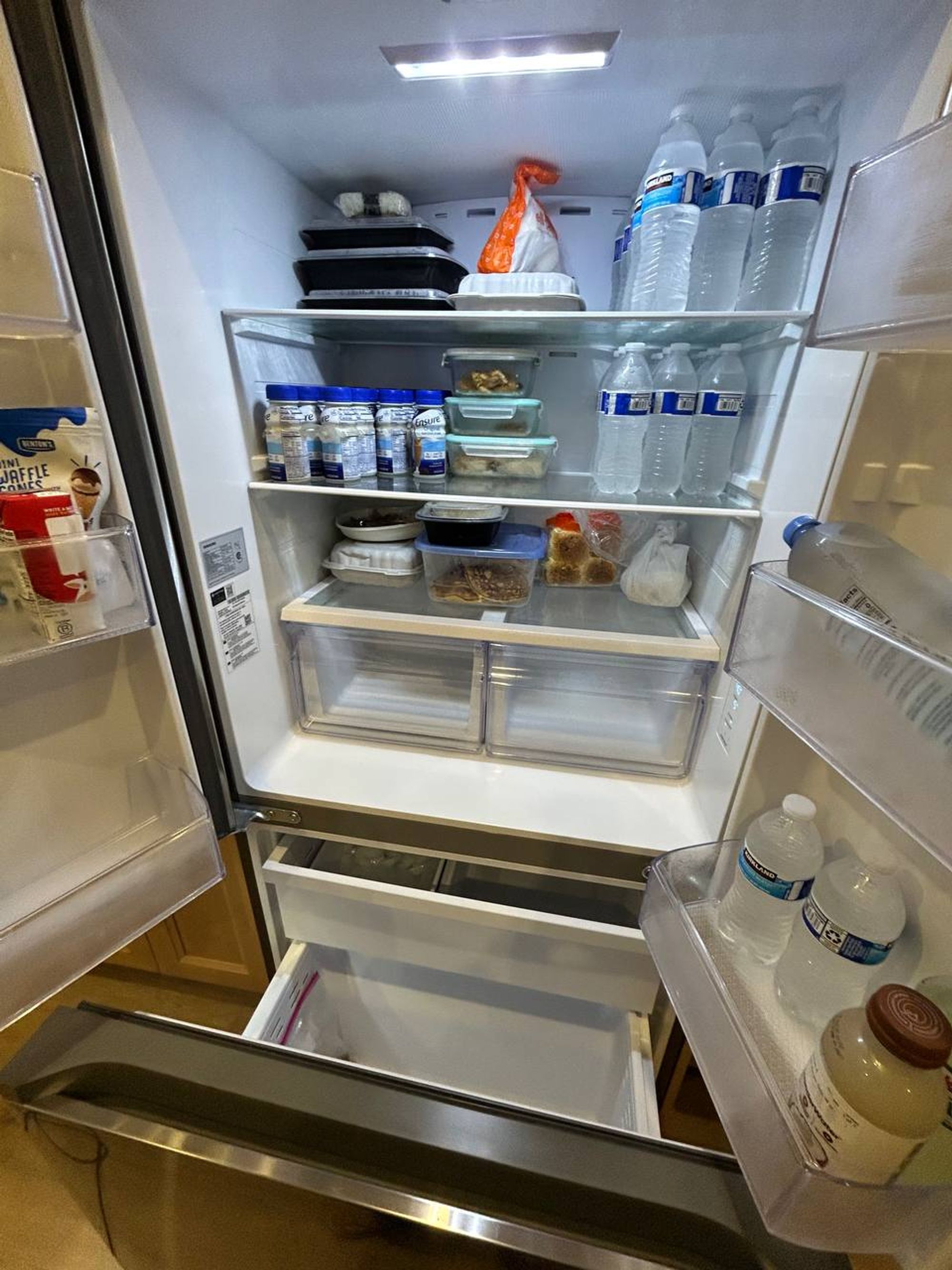 French door fridge with wiped shelves and neatly stocked food