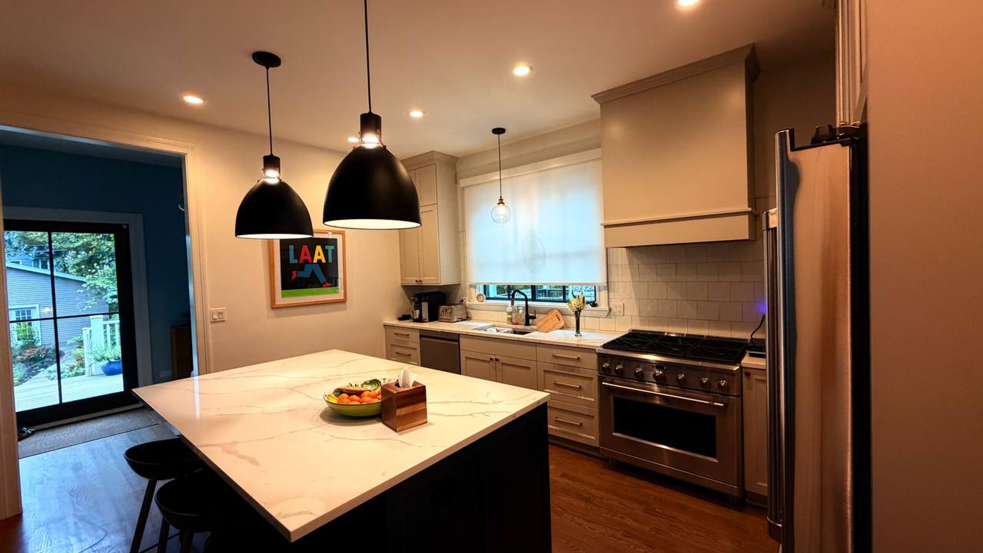 Kitchen island and gas range with light shaker cabinets