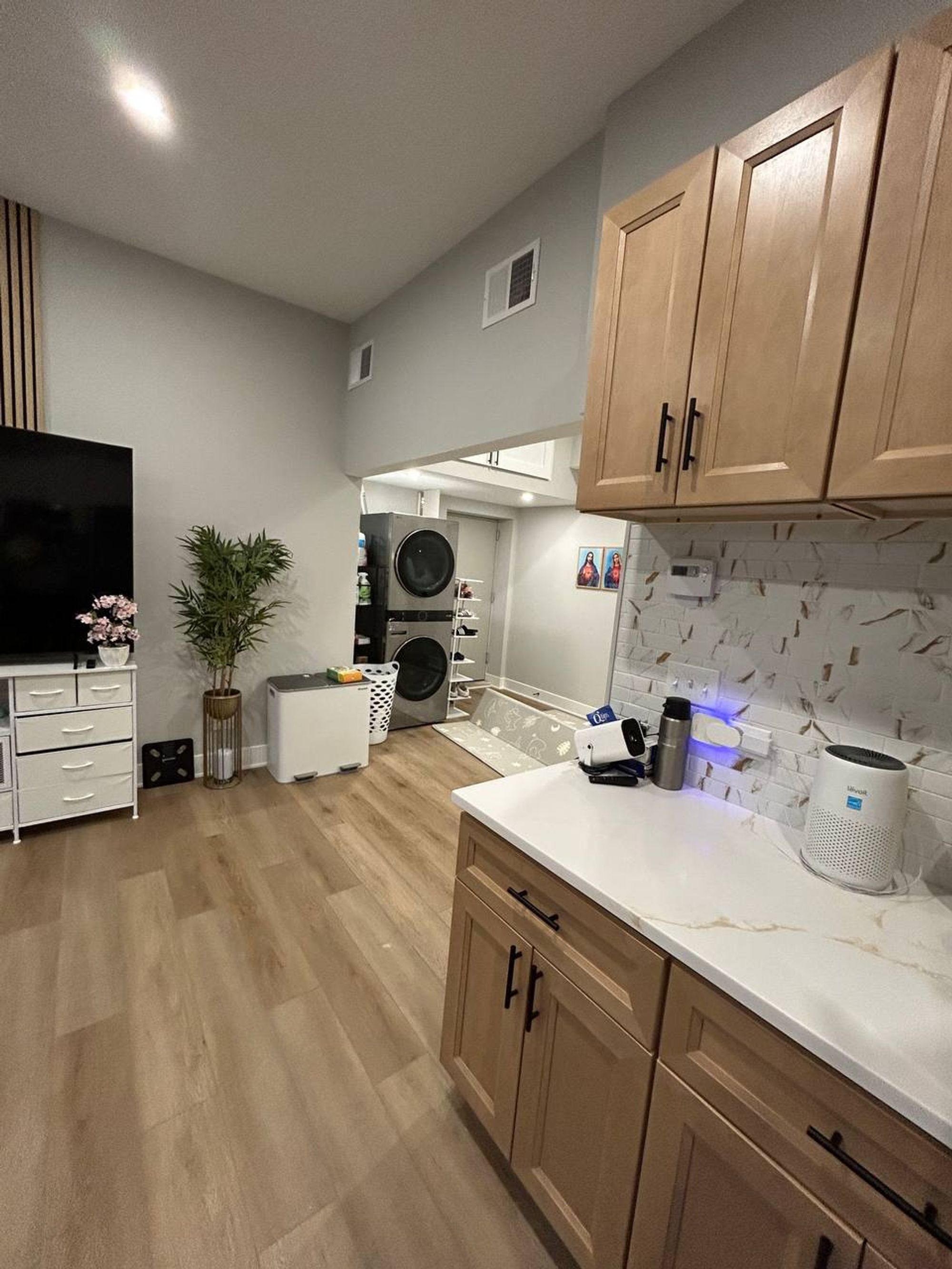 Open kitchen and living area with wood cabinets and plank floor