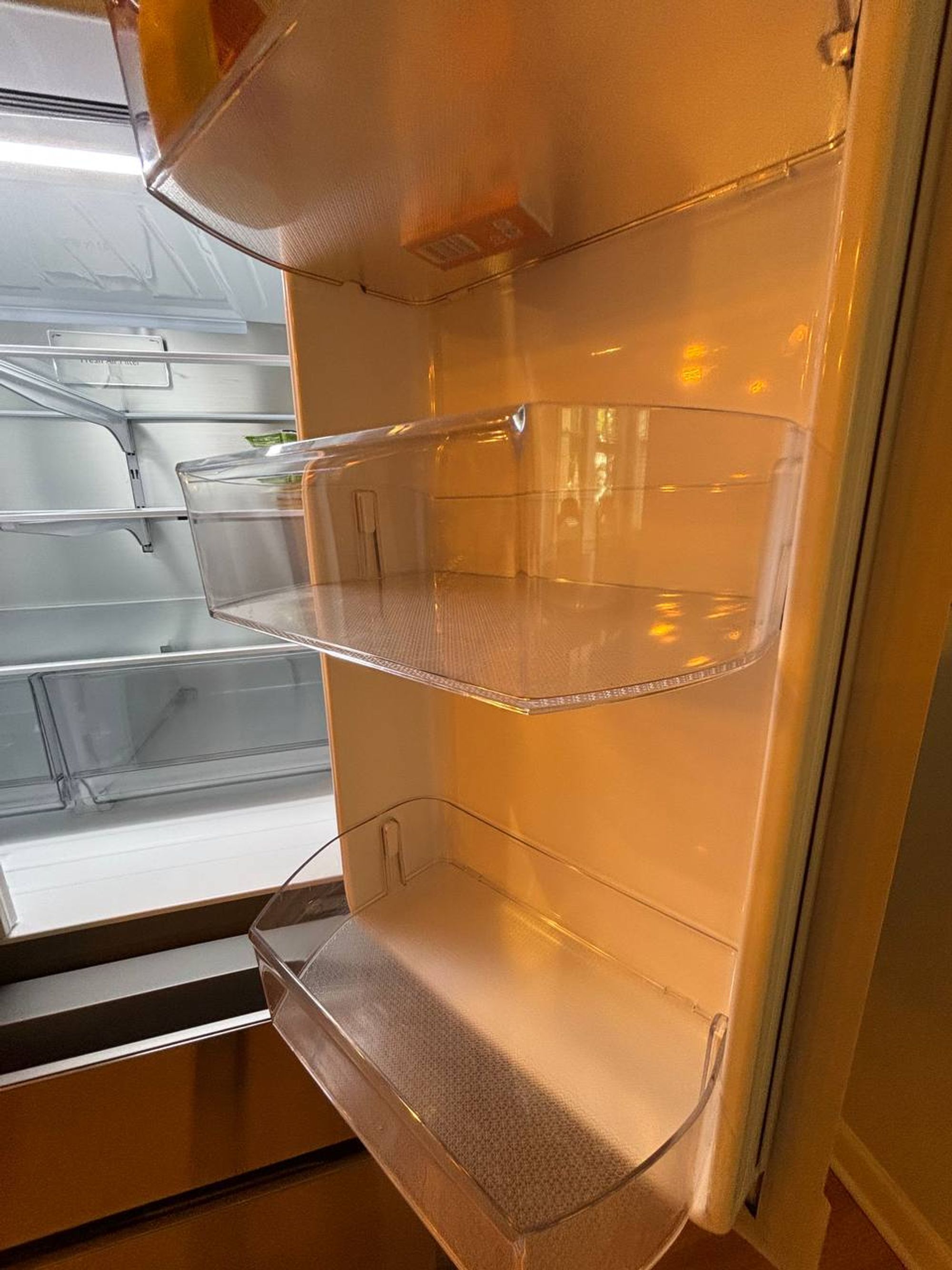 Clean clear door bins inside a French door fridge