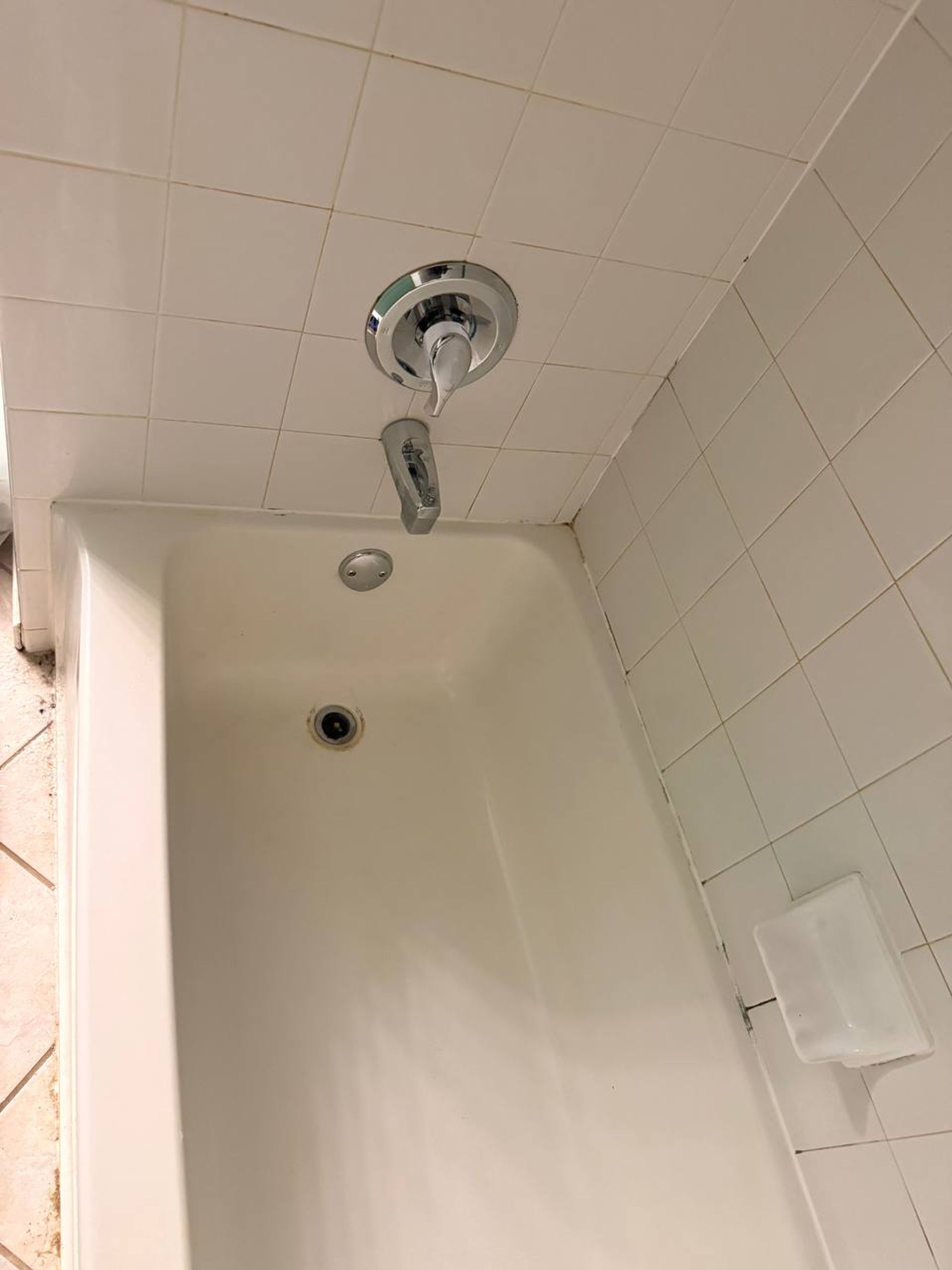 Scrubbed white tub with chrome spout and clean wall tile