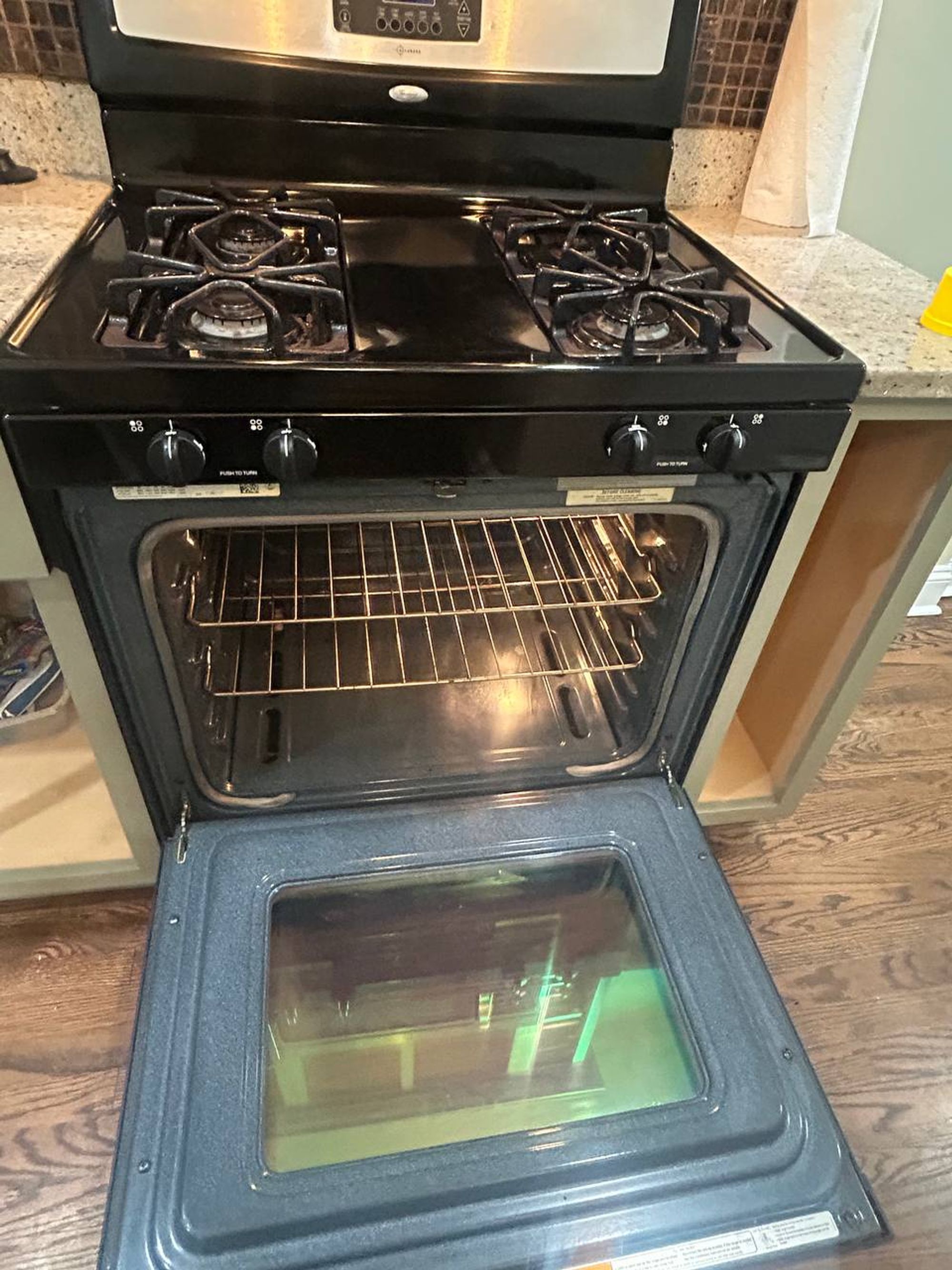 Open gas oven with clean racks and wiped door window