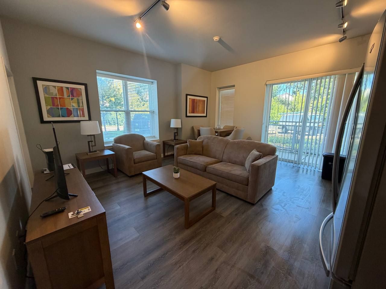 Furnished living room with sofa, armchair, coffee table and sliding door