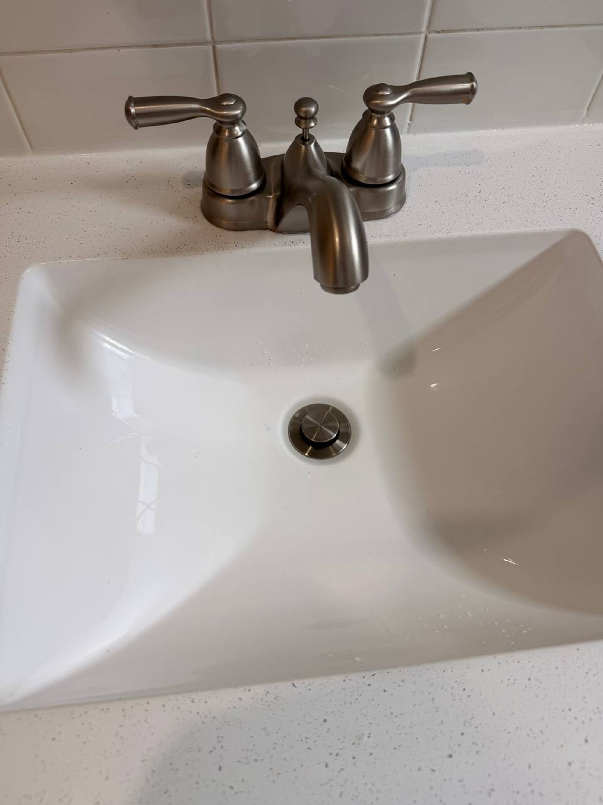 Clean square white sink with brushed nickel faucet