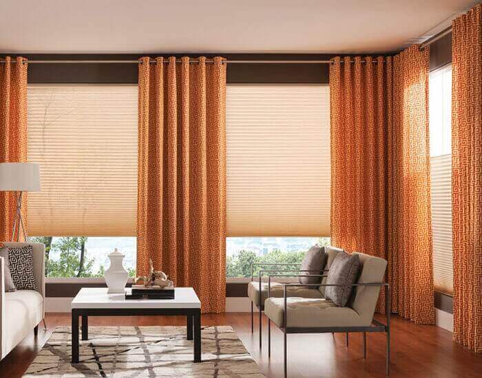 Curtains over outlet blinds