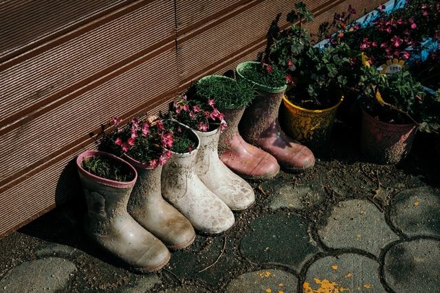 Old boots planters for balcony decor