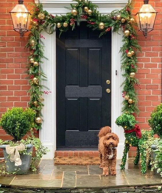 Garland hanging over front door with garland hangers